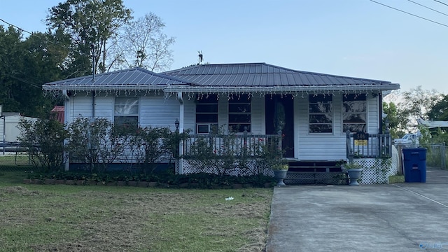 view of front of property with covered porch and a front yard