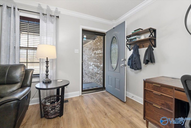 foyer with light wood-style floors, baseboards, and crown molding