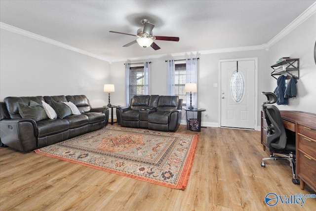 living area with light wood-style flooring, ornamental molding, and baseboards