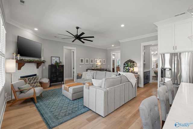 6320 Loring Loop NW, Huntsville, AL 35806 - living area with a fireplace, light wood-type flooring, recessed lighting, ceiling fan, and crown molding