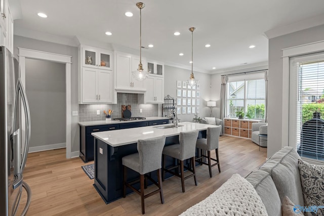6320 Loring Loop NW, Huntsville, AL 35806 - kitchen featuring stainless steel appliances, ornamental molding, white cabinets, light countertops, and a kitchen breakfast bar