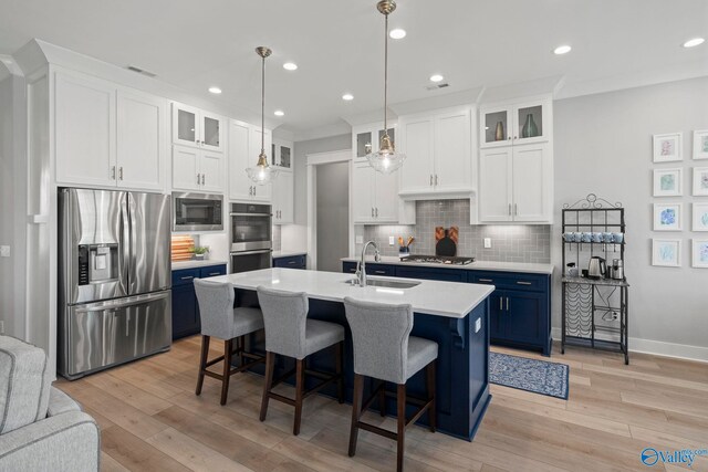 6320 Loring Loop NW, Huntsville, AL 35806 - kitchen with appliances with stainless steel finishes, blue cabinets, light countertops, a kitchen breakfast bar, and recessed lighting