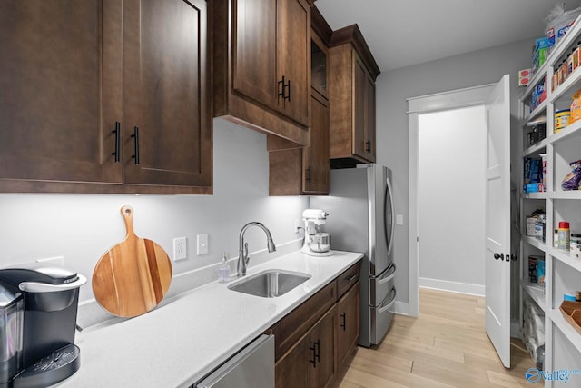 6320 Loring Loop NW, Huntsville, AL 35806 - kitchen with dark brown cabinetry, freestanding refrigerator, light wood-style flooring, and dishwasher