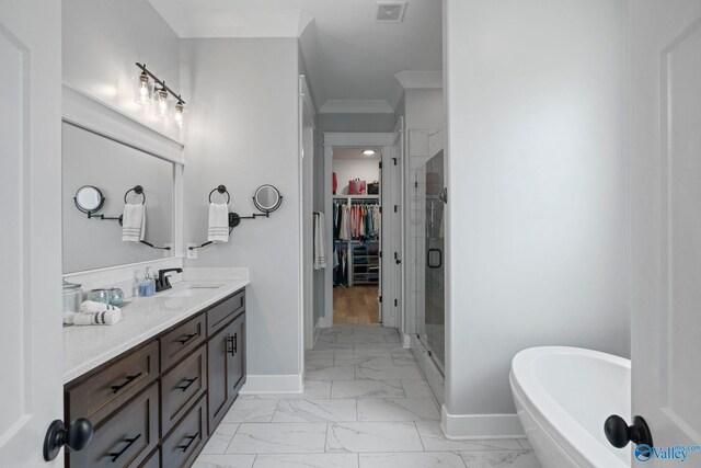 6320 Loring Loop NW, Huntsville, AL 35806 - bathroom featuring marble look tile flooring, a spacious closet, double vanity, a shower stall, and a soaking tub