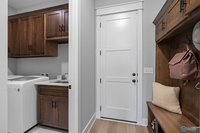 6320 Loring Loop NW, Huntsville, AL 35806 - laundry room featuring cabinet space, light wood-style floors, and washer and clothes dryer