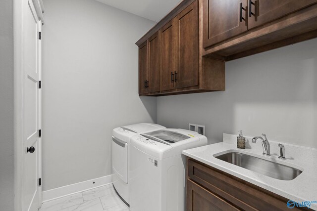 6320 Loring Loop NW, Huntsville, AL 35806 - laundry area featuring cabinet space, washing machine and dryer, and light marble finish flooring
