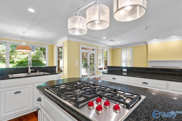 kitchen with white cabinetry, sink, gas cooktop, crown molding, and french doors