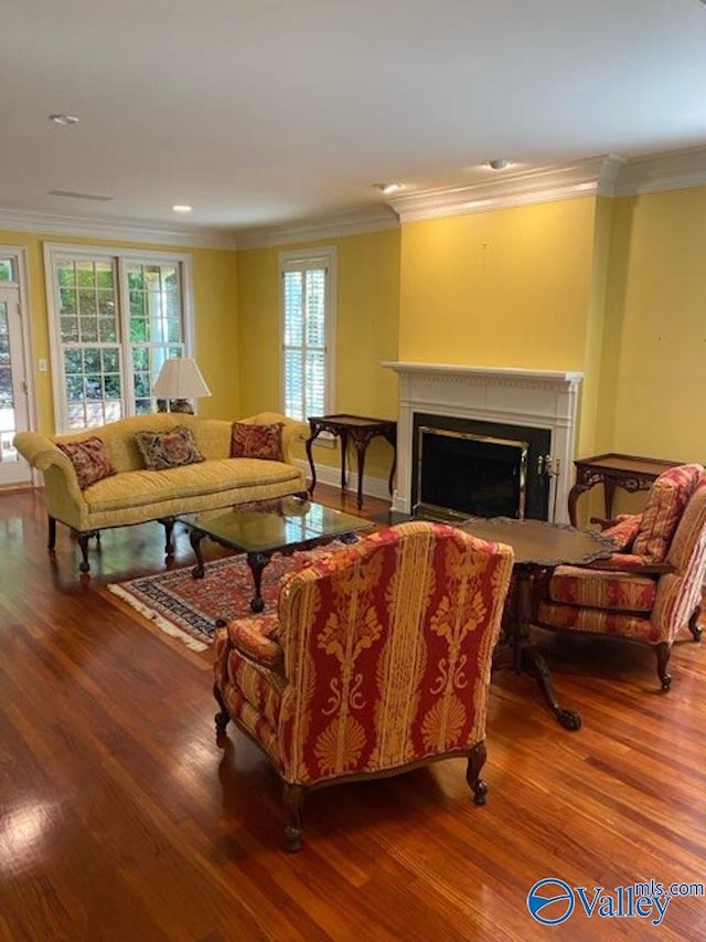 living room featuring plenty of natural light and ornamental molding