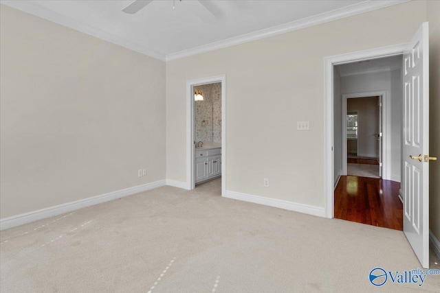 unfurnished bedroom with light carpet, crown molding, ensuite bath, and ceiling fan