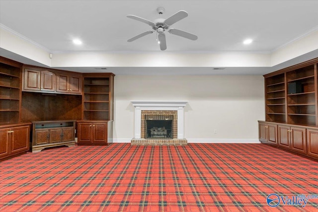 unfurnished living room with ceiling fan, ornamental molding, a fireplace, and carpet floors