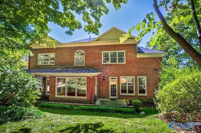 view of front facade with a patio and a front yard