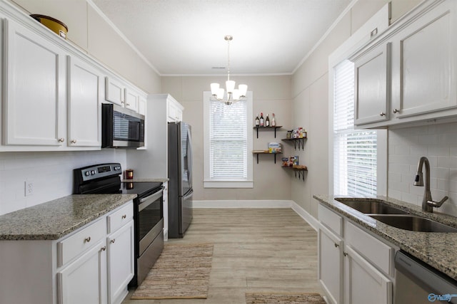 kitchen featuring white cabinets, stainless steel appliances, light hardwood / wood-style flooring, and sink