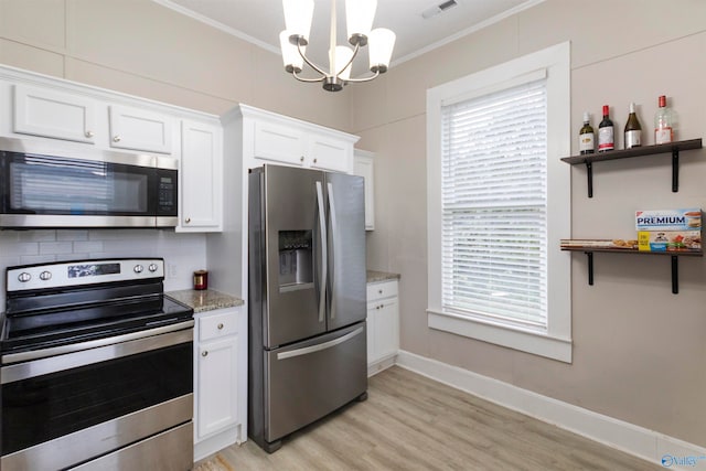 kitchen with white cabinets, appliances with stainless steel finishes, light wood-type flooring, and crown molding