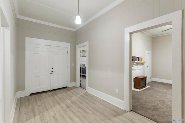 interior space featuring light hardwood / wood-style floors and ornamental molding