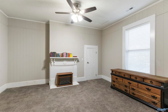 misc room with carpet flooring, ceiling fan, and ornamental molding