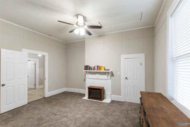 misc room featuring carpet, plenty of natural light, ornamental molding, and ceiling fan