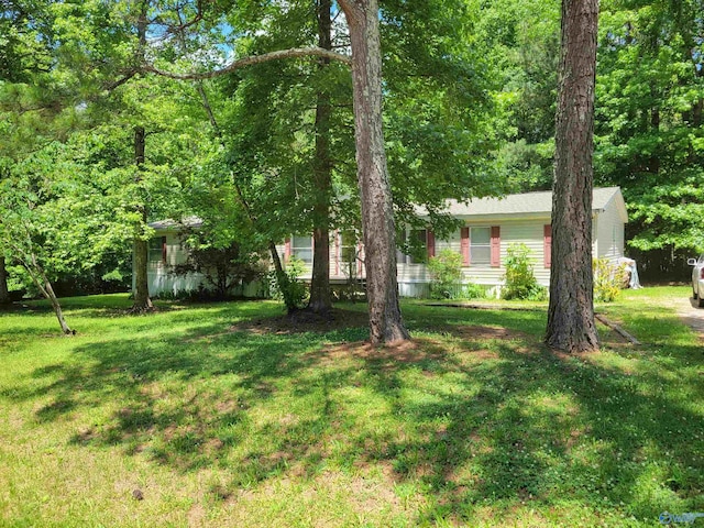 view of home's exterior with a yard and a wooden deck