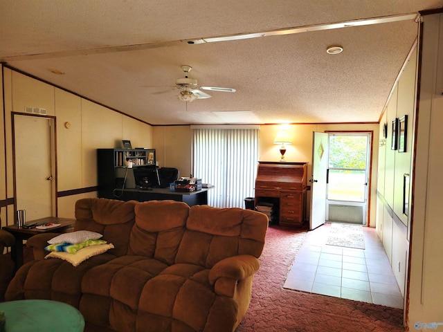 tiled living room featuring ceiling fan, vaulted ceiling, and a textured ceiling