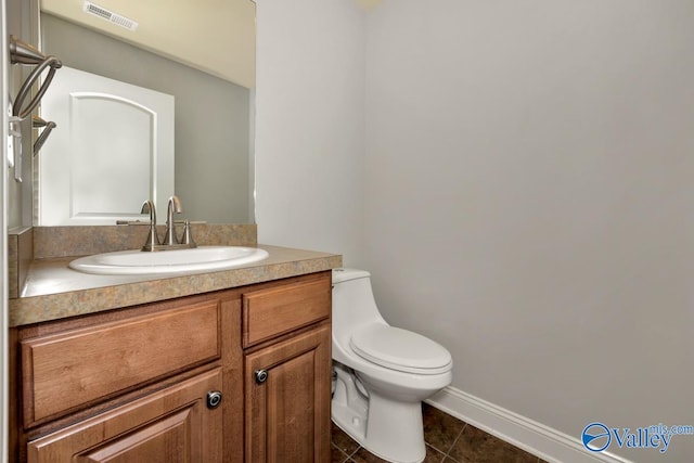 bathroom with tile patterned floors, vanity, and toilet