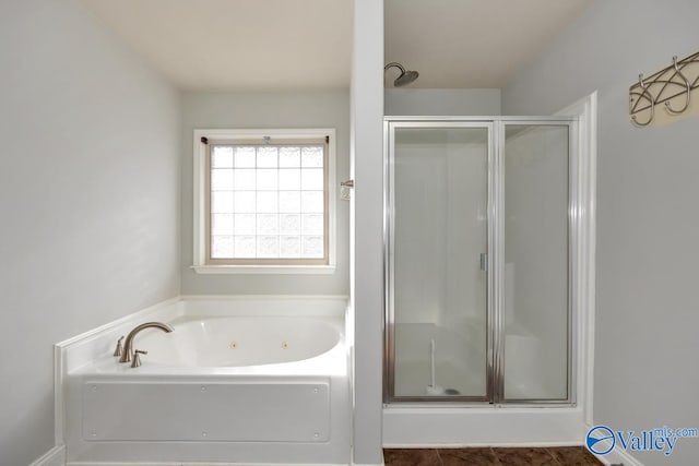 bathroom featuring independent shower and bath