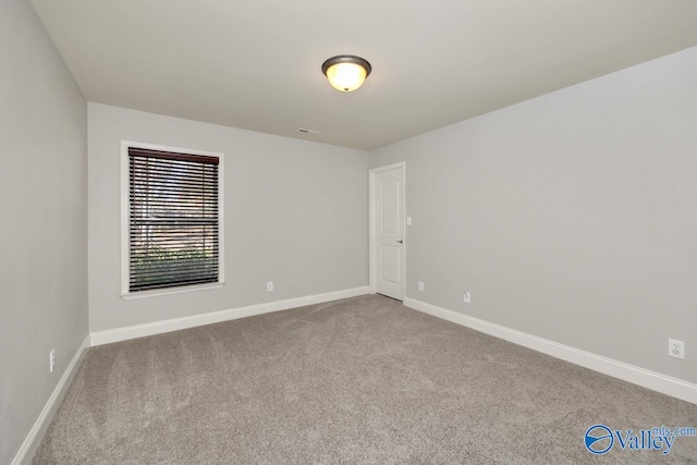 spare room featuring light colored carpet