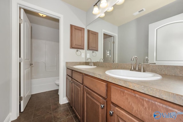 bathroom featuring tile patterned floors, vanity, and toilet