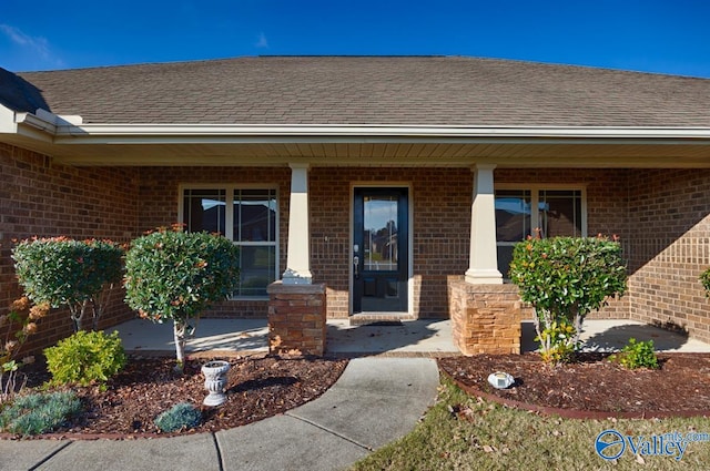 view of exterior entry featuring covered porch