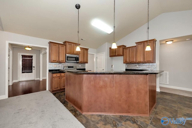 kitchen featuring backsplash, stainless steel appliances, a center island with sink, high vaulted ceiling, and hanging light fixtures