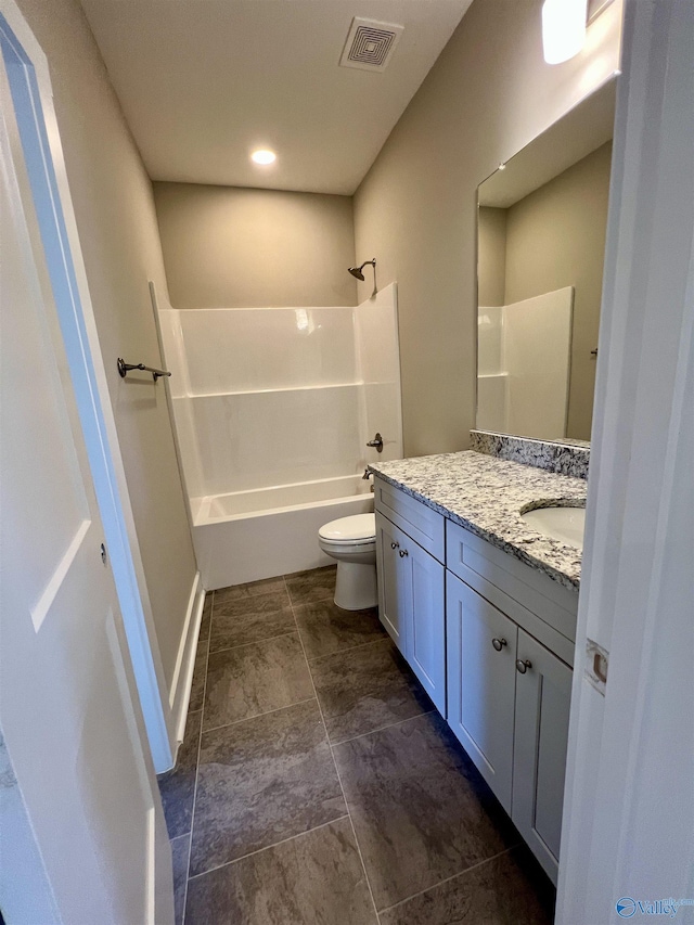 bathroom with baseboards, visible vents, toilet, vanity, and washtub / shower combination