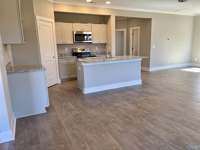 kitchen featuring ornamental molding, dark wood-style flooring, light stone countertops, stainless steel appliances, and a sink