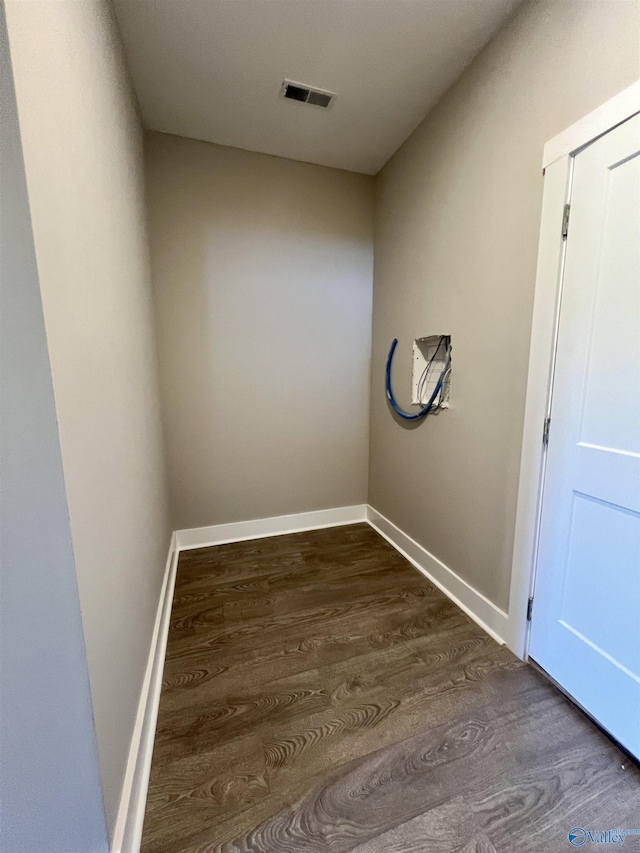 interior space featuring wood finished floors, visible vents, and baseboards