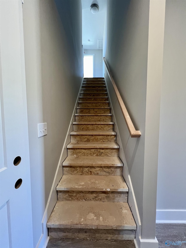 stairway featuring baseboards