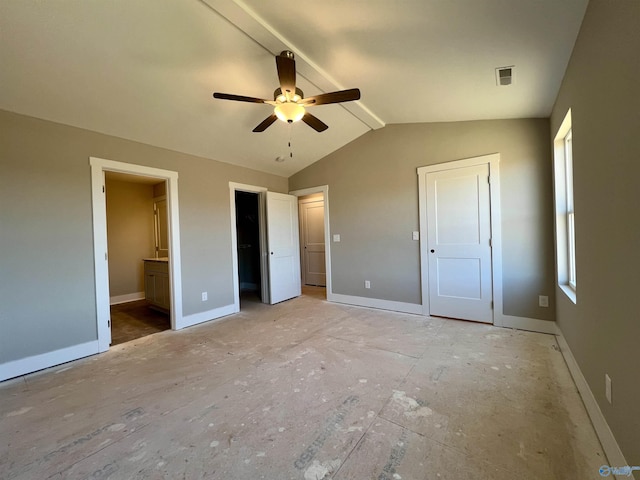 unfurnished bedroom featuring vaulted ceiling with beams, baseboards, and ensuite bathroom