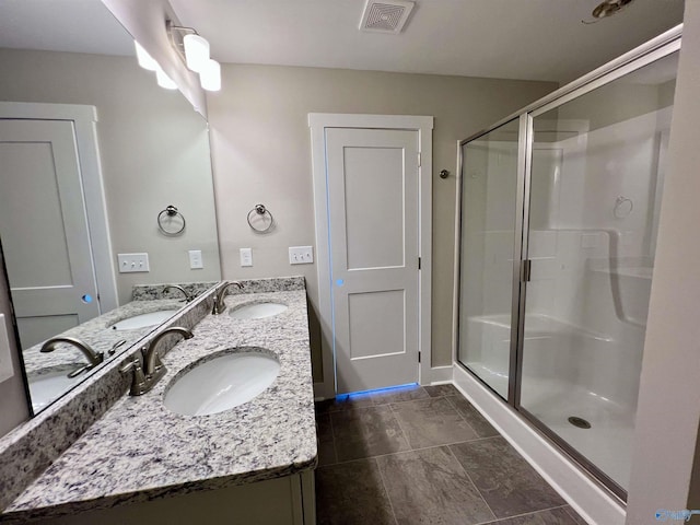 bathroom with a sink, visible vents, and a shower stall