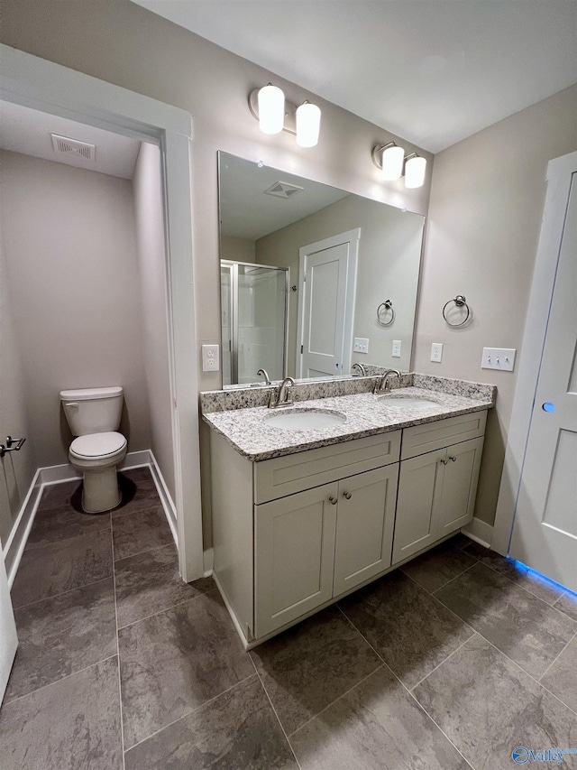 bathroom with a stall shower, a sink, and visible vents