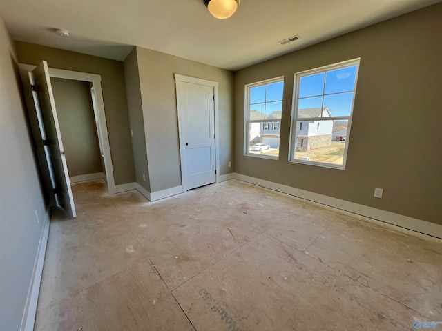 unfurnished bedroom with a closet, visible vents, and baseboards