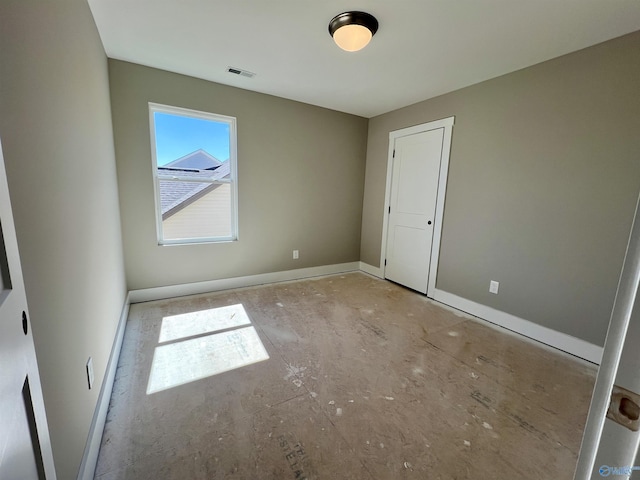 unfurnished bedroom with baseboards and visible vents