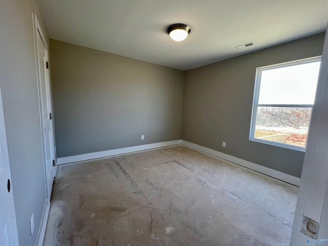 spare room featuring visible vents and baseboards