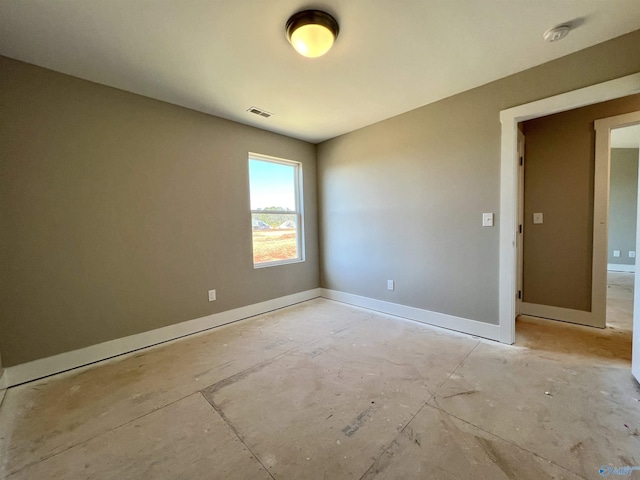 unfurnished room with visible vents and baseboards