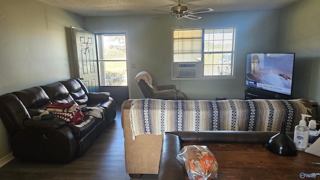 living room with ceiling fan, plenty of natural light, and a textured ceiling