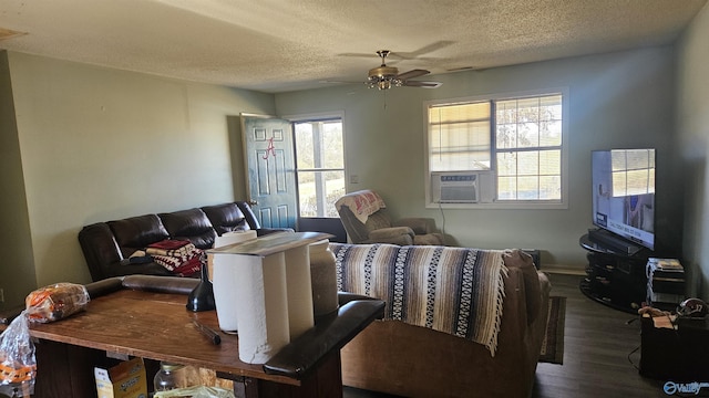 living room featuring a textured ceiling, ceiling fan, cooling unit, and plenty of natural light