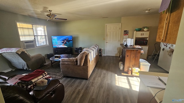 living room featuring ceiling fan and dark hardwood / wood-style flooring