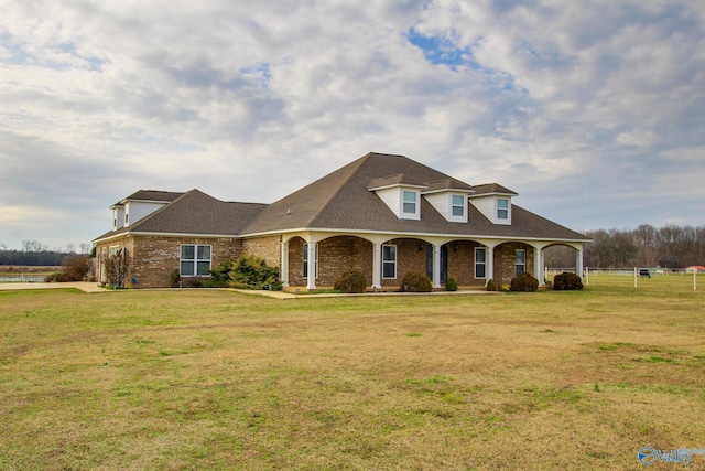 cape cod-style house with covered porch and a front lawn