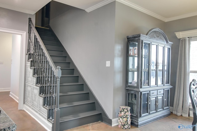 staircase featuring crown molding and tile patterned floors