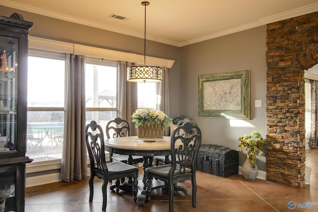 dining room featuring crown molding