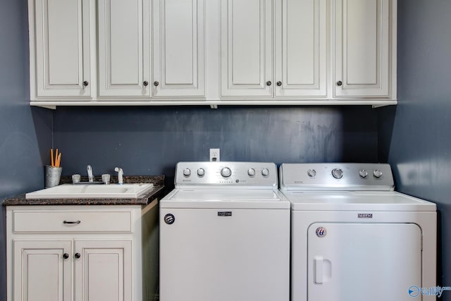 laundry room with cabinets, sink, and washing machine and dryer