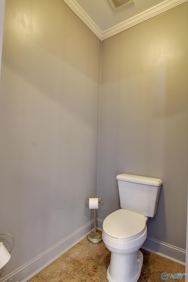 bathroom featuring crown molding and toilet