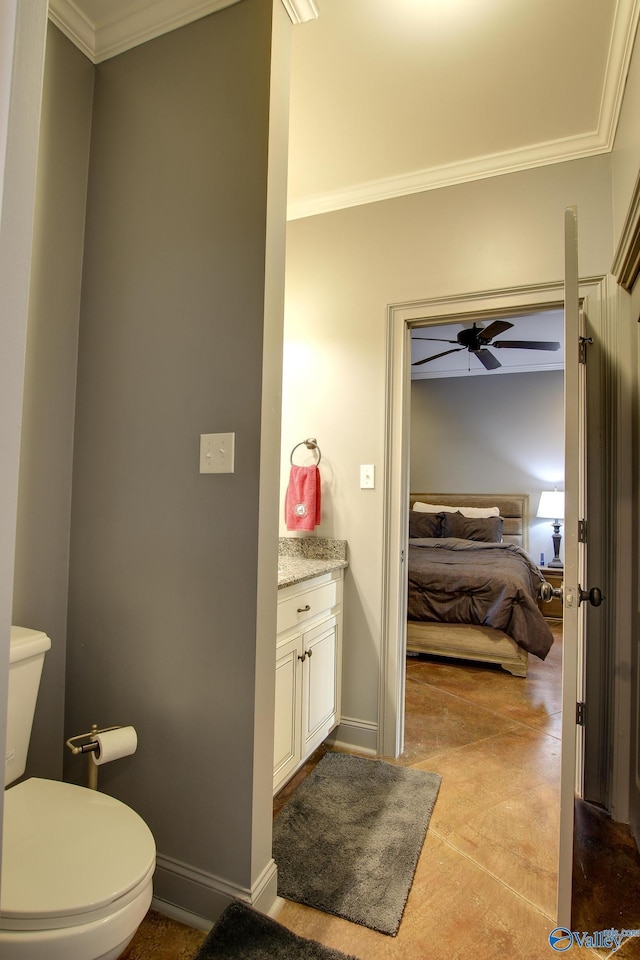 bathroom featuring vanity, ceiling fan, crown molding, and toilet