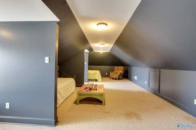 interior space featuring vaulted ceiling and carpet flooring