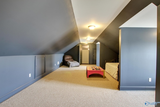 bedroom featuring lofted ceiling and light colored carpet